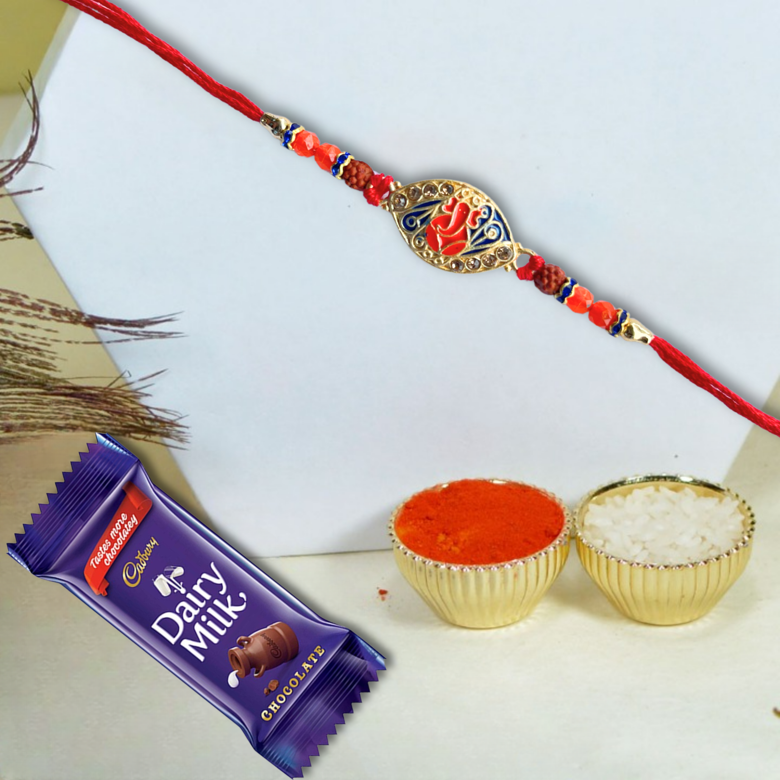 Ganesh Rudraksha Rakhi with Cadbury Dairy Milk Chocolate Bar , 21 g