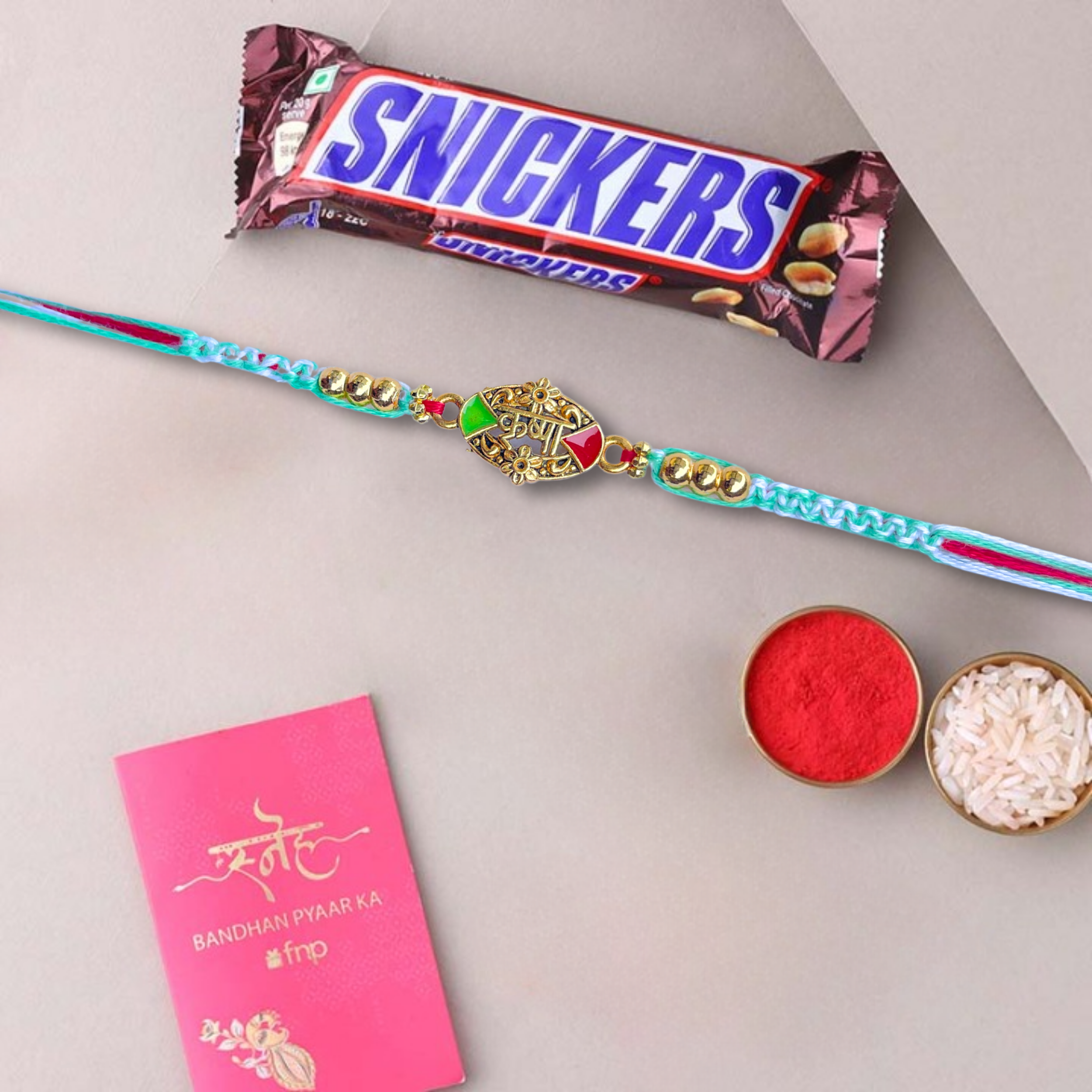 Golden Krishna Rakhi With Snickers Peanut Filled Chocolate Bar, 20 g