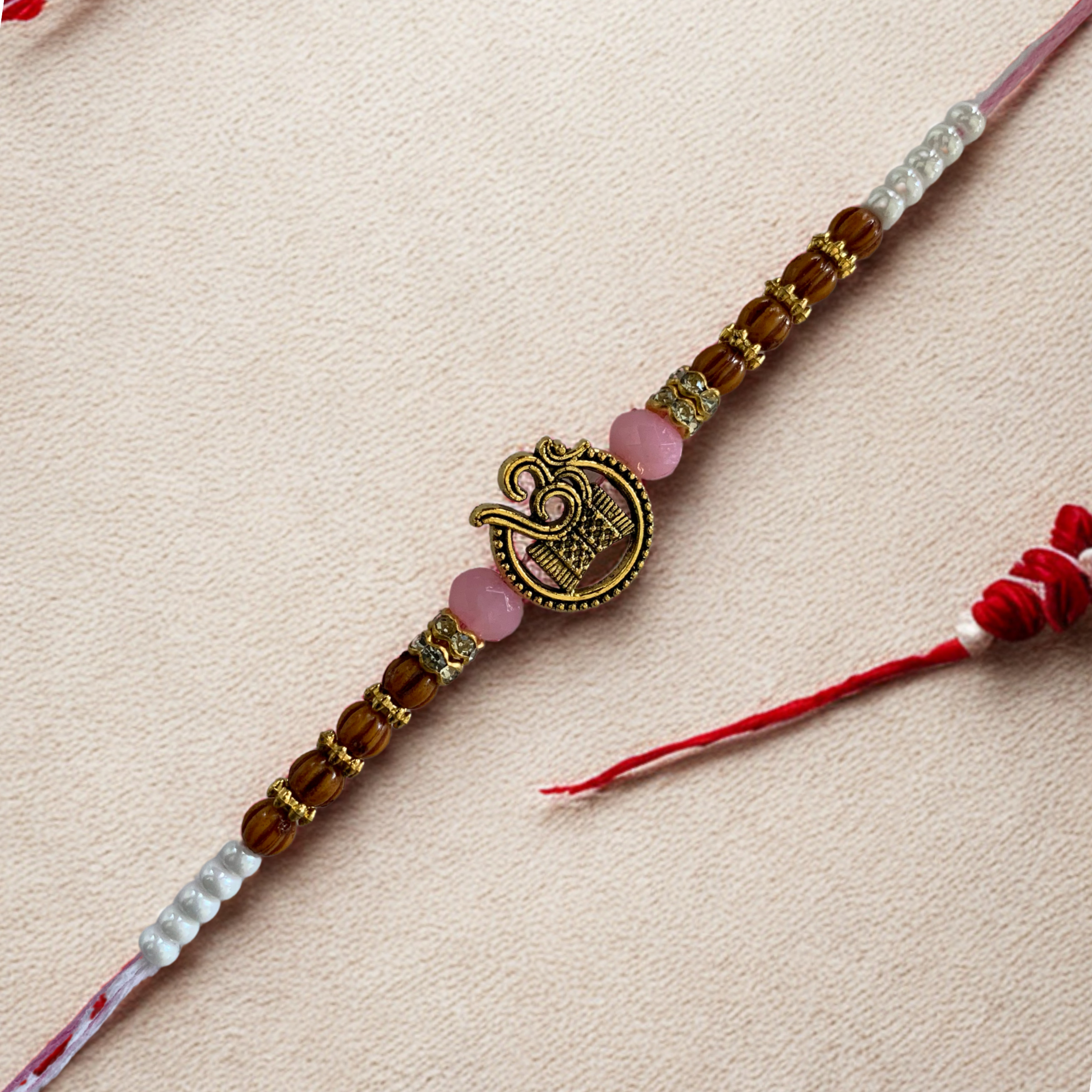 Spiritual Om Rakhi with Wooden & Light Pink Beads