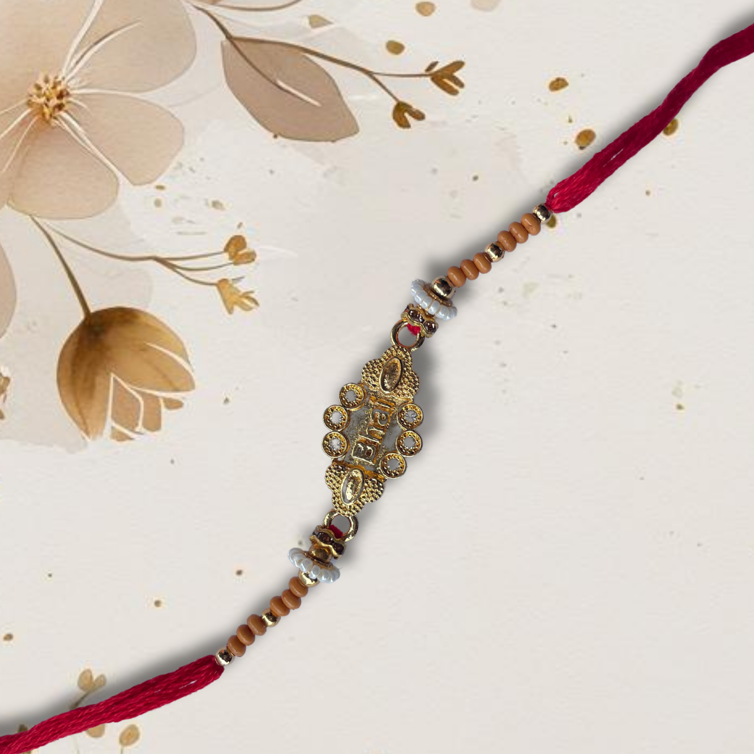 Elegant Rakhi with a golden “Bhai” centerpiece, pearls, and red thread