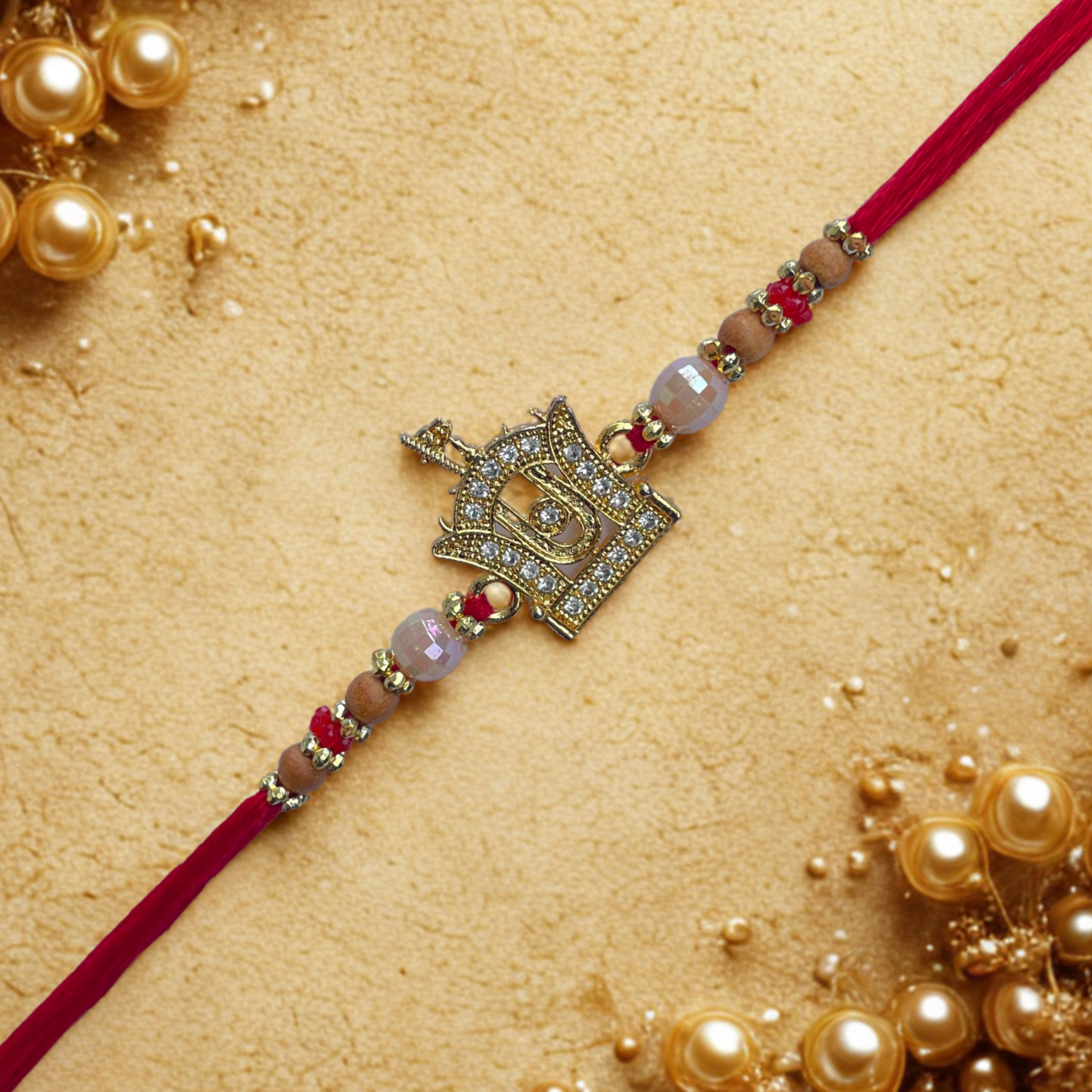 Swaminarayan Akshar Deri Motif Golden Rakhi with Red Thread & Beads
