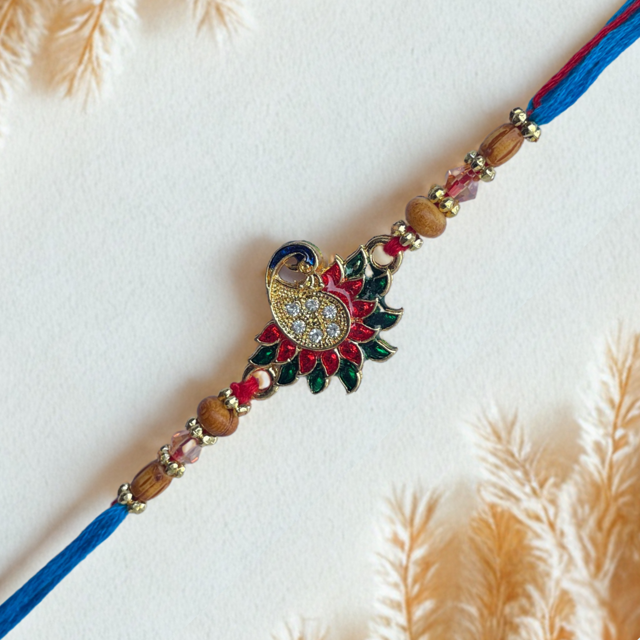 Colorful Peacock Design Rakhi with Blue-Red Thread & Golden Beads