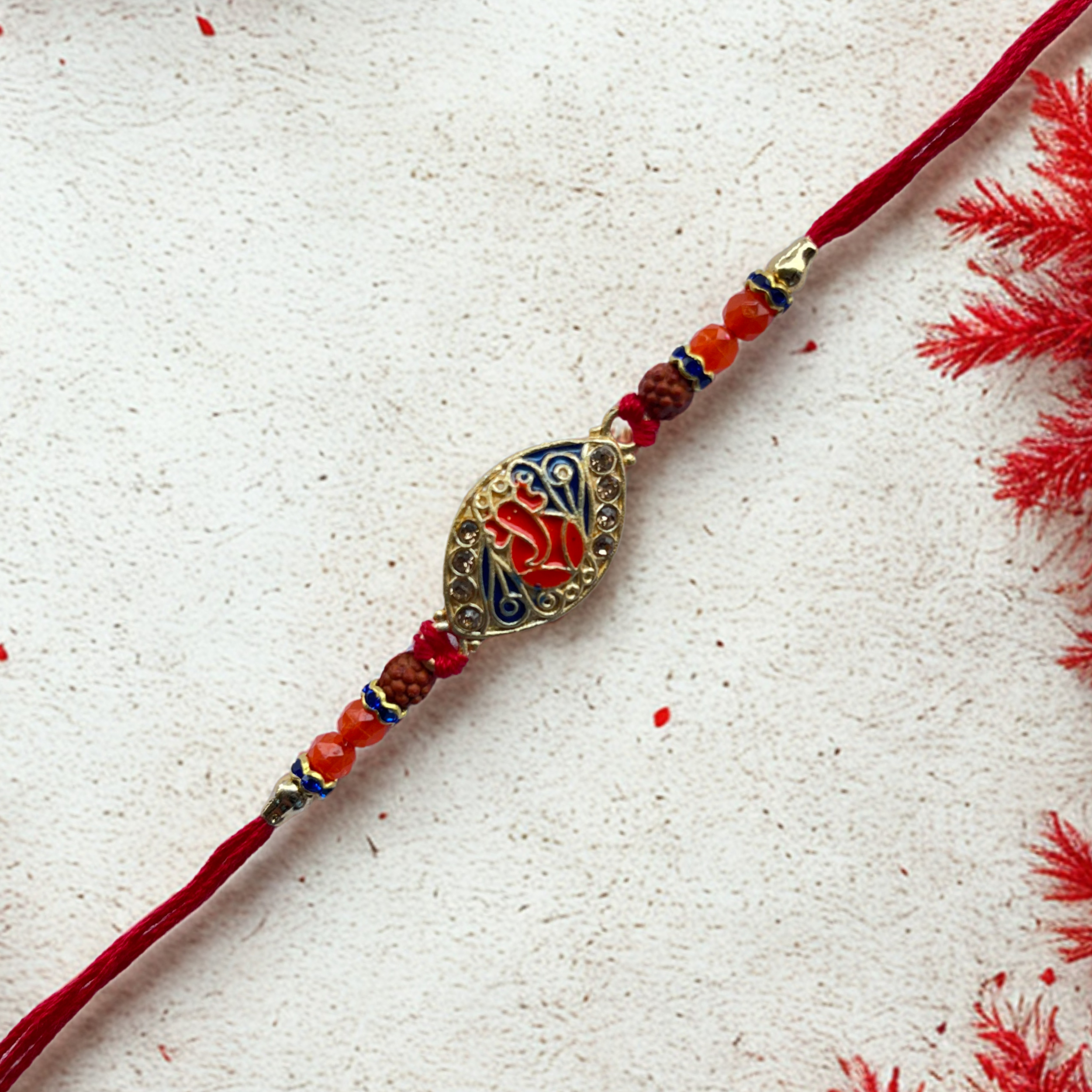 Ganesh Rudraksha Rakhi with Enamel Gold Finish