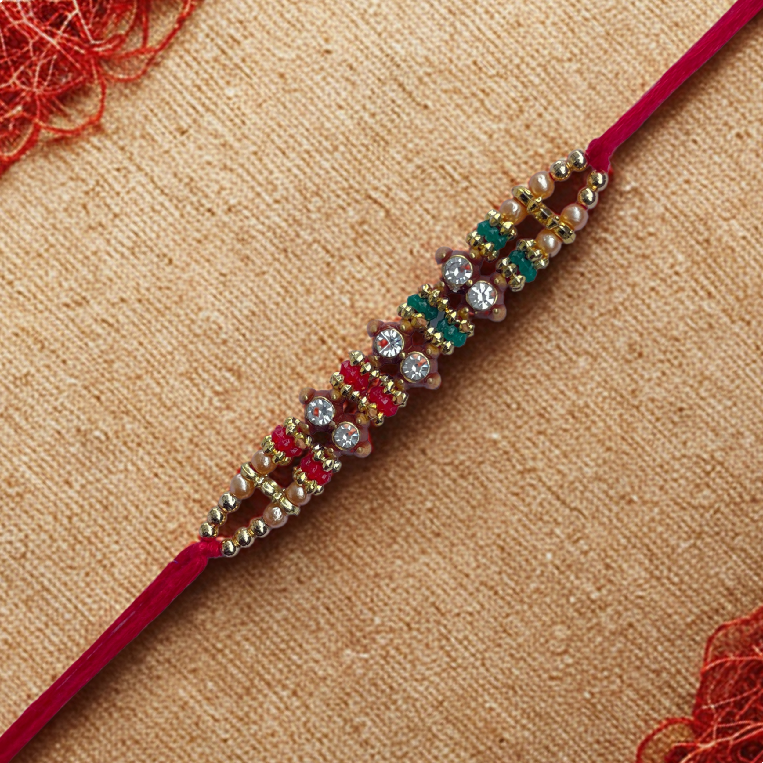 Elegant Beaded Rakhi with Red-Green Accents & Stones