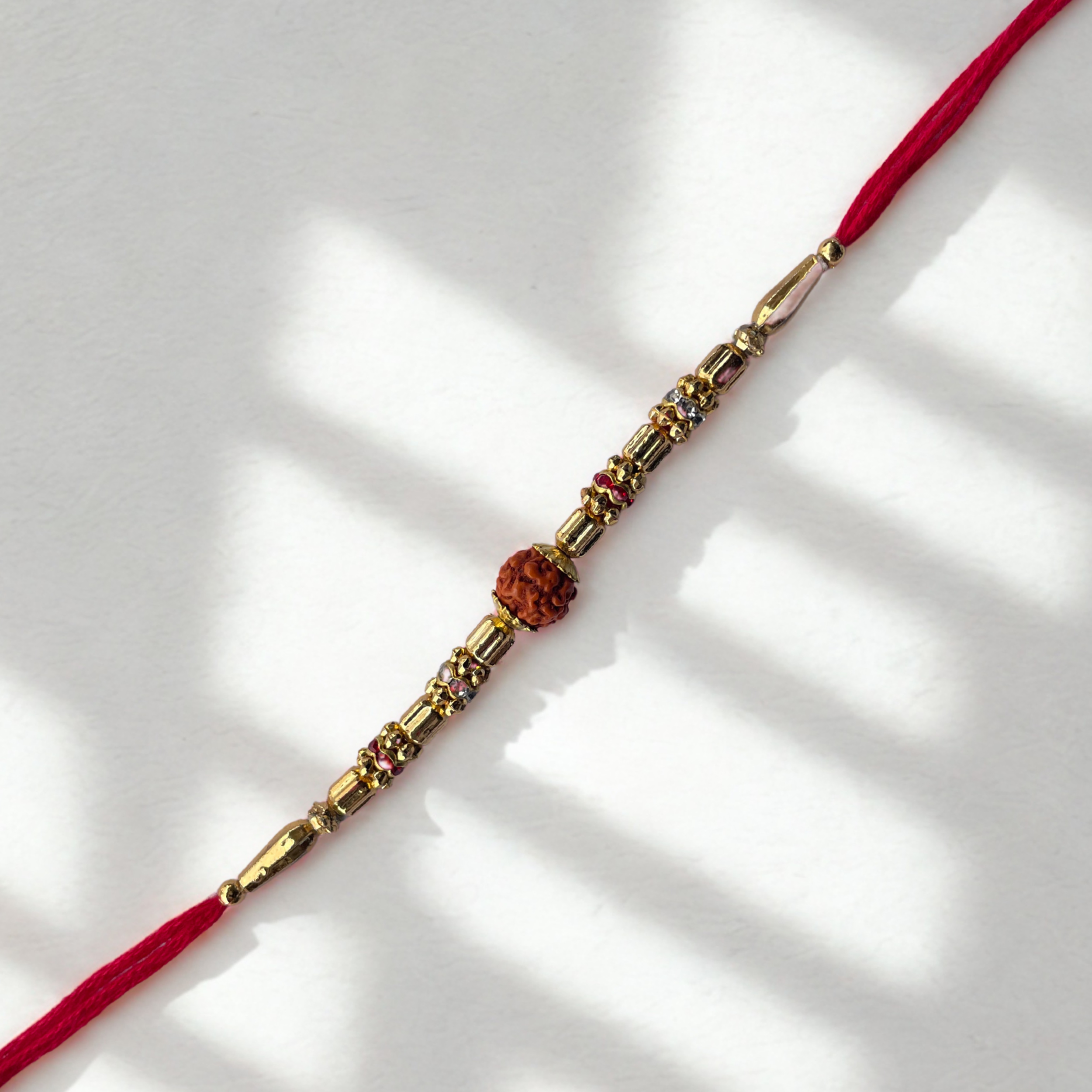 Rudraksha Rakhi with Golden Beads & Sacred Red Thread