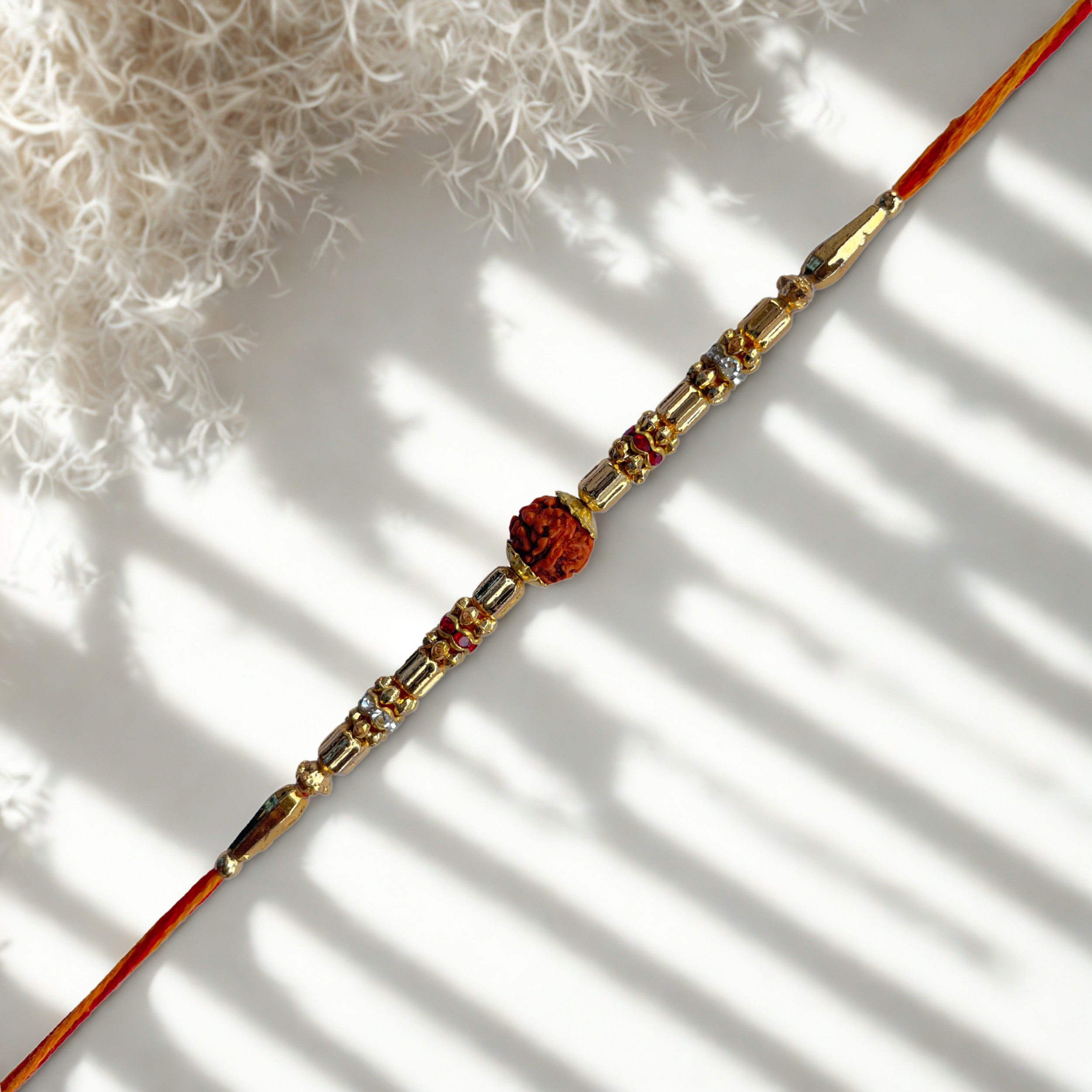 Rudraksha Rakhi with Golden Beads & Sacred Yellow Thread