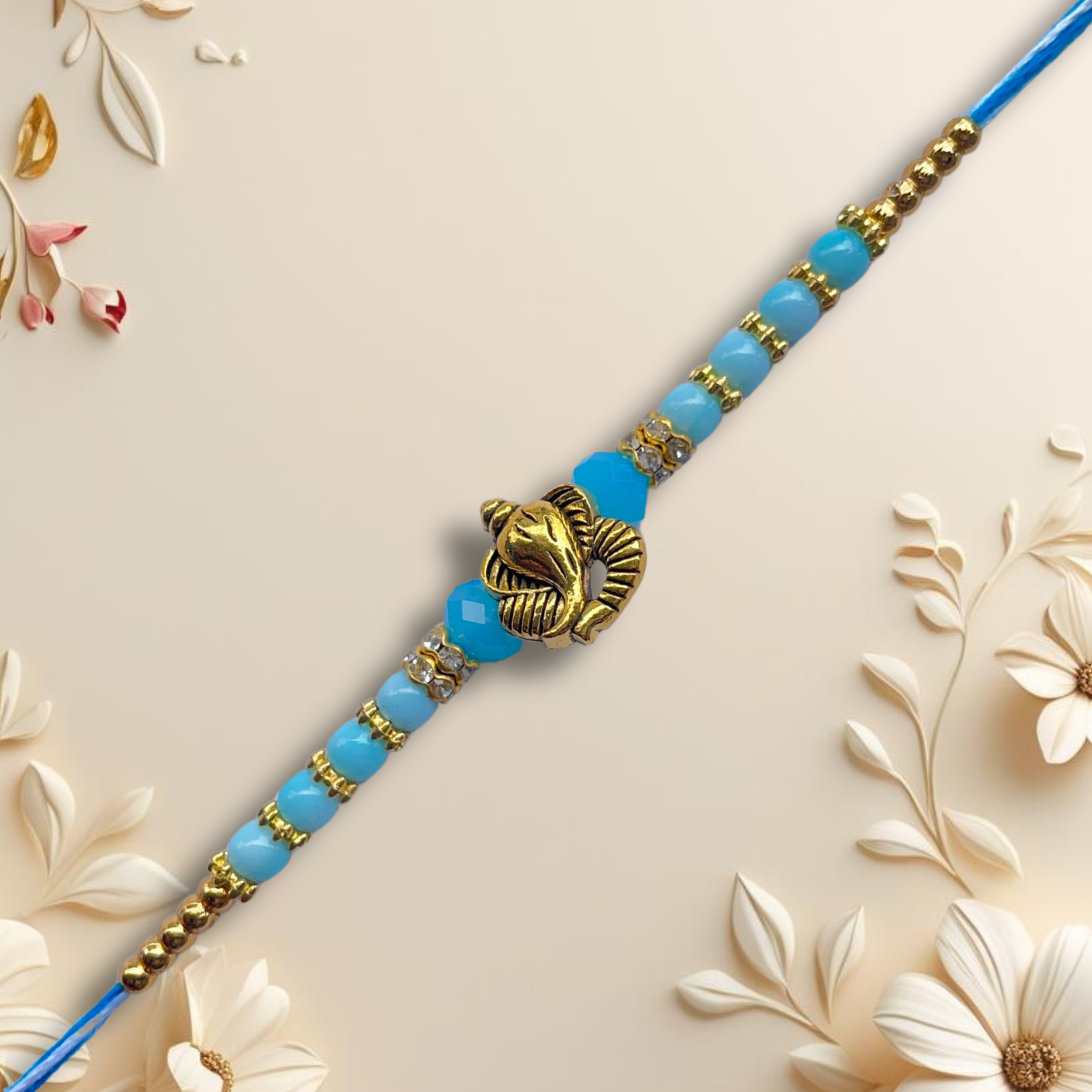 Ganesh Motif Rakhi with Light Blue Beads & Golden Accents