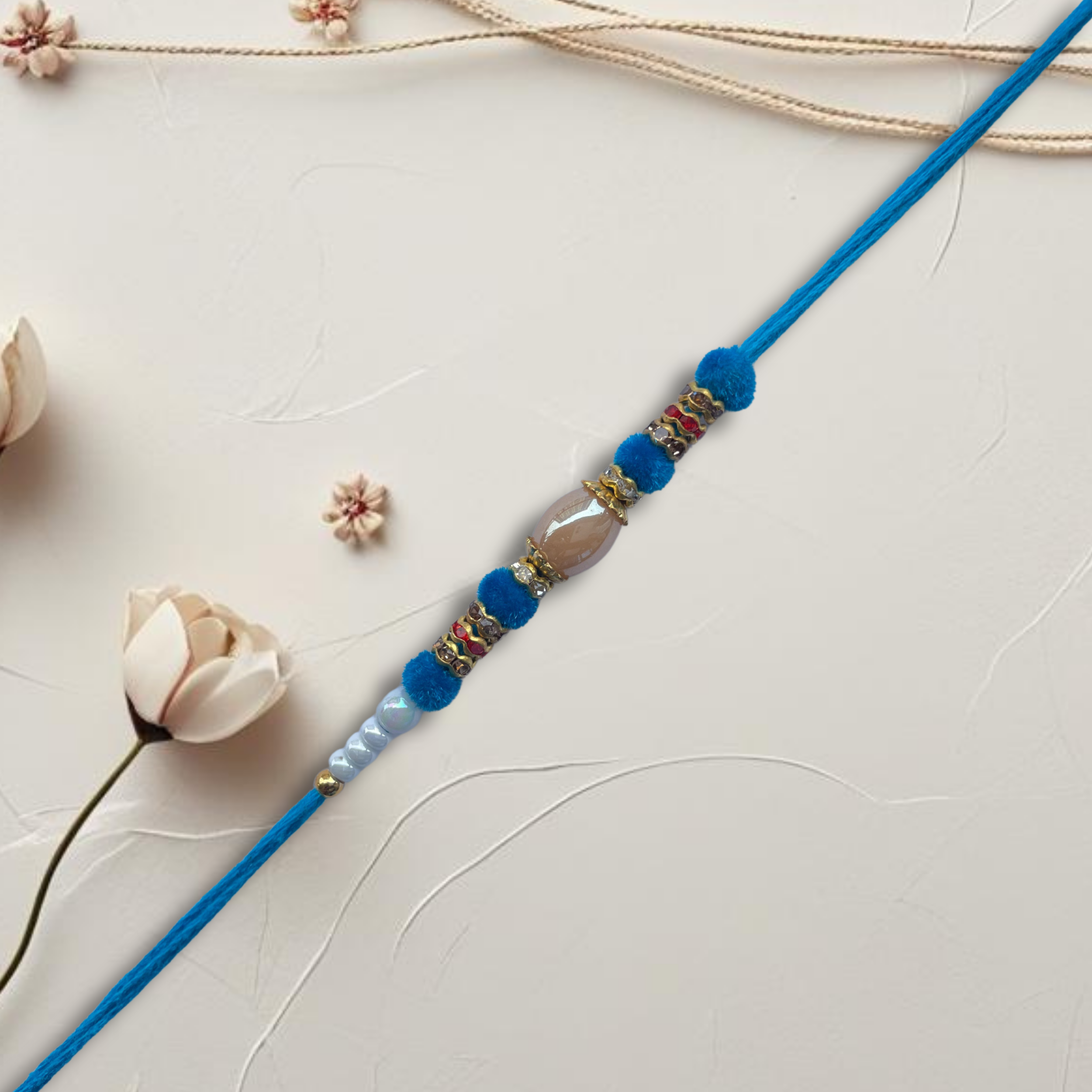 Elegant Light Blue & White Beaded Rakhi with Central Crystal Bead