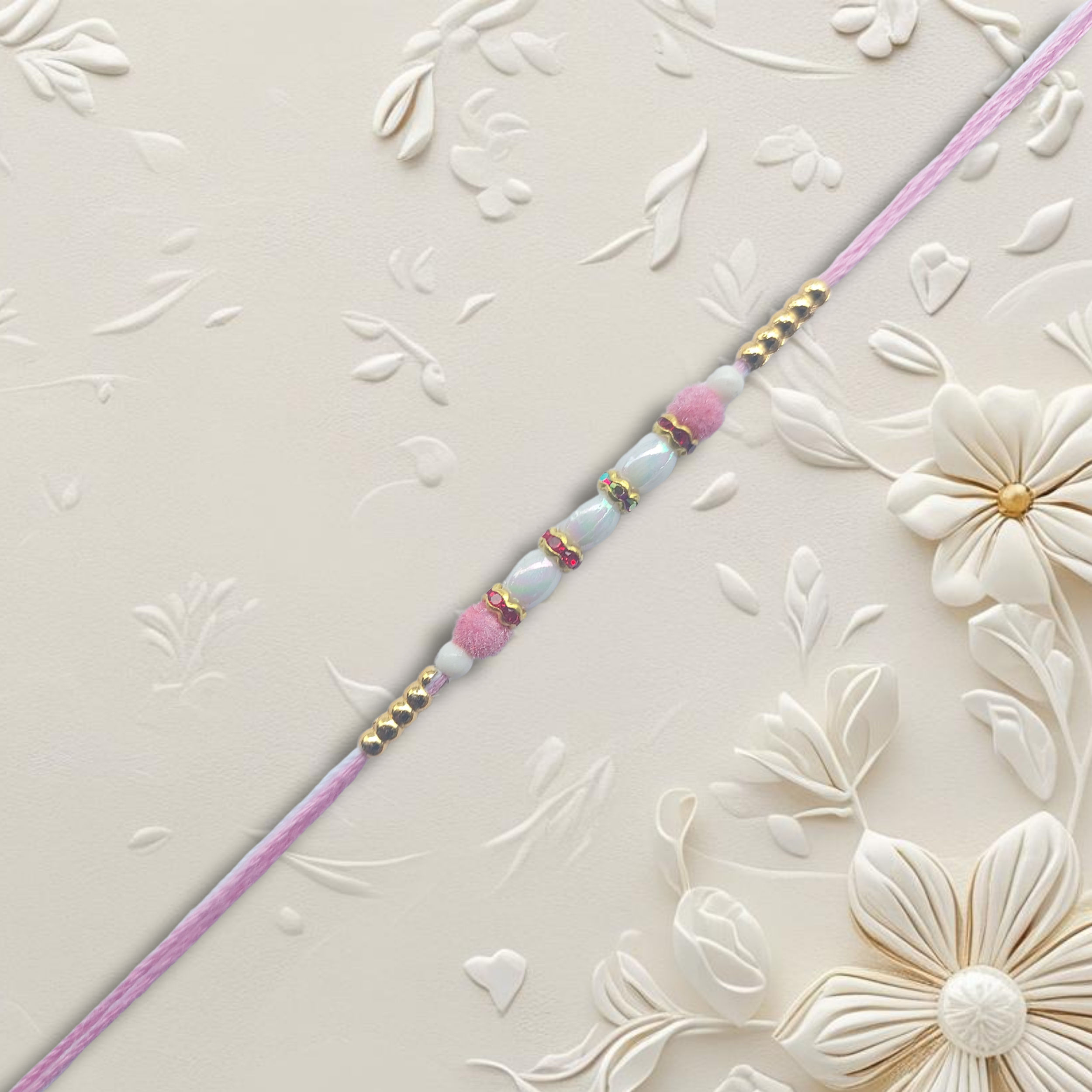 Light Pink Pearl Rakhi with Golden Bead Accents