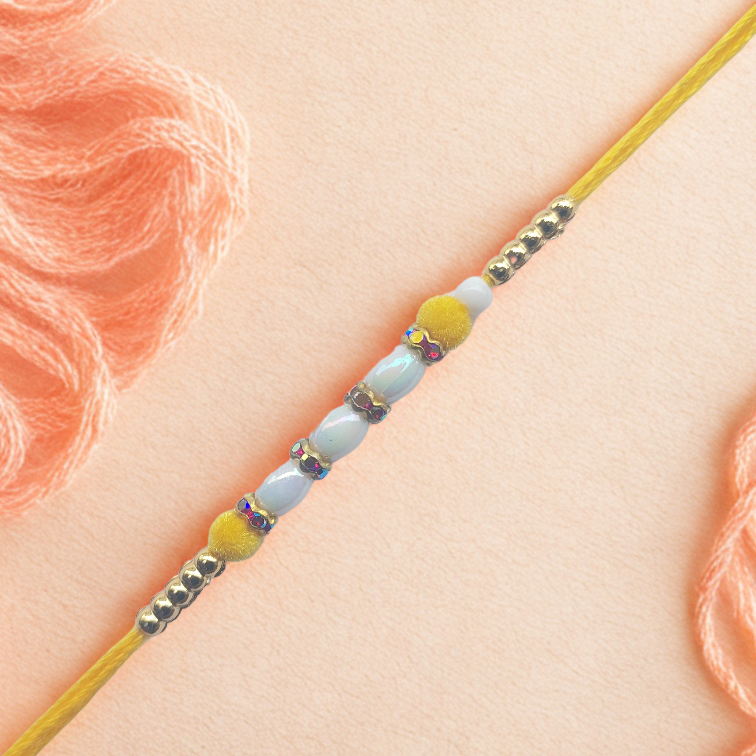 Yellow Pearl Rakhi with Golden Bead Accents