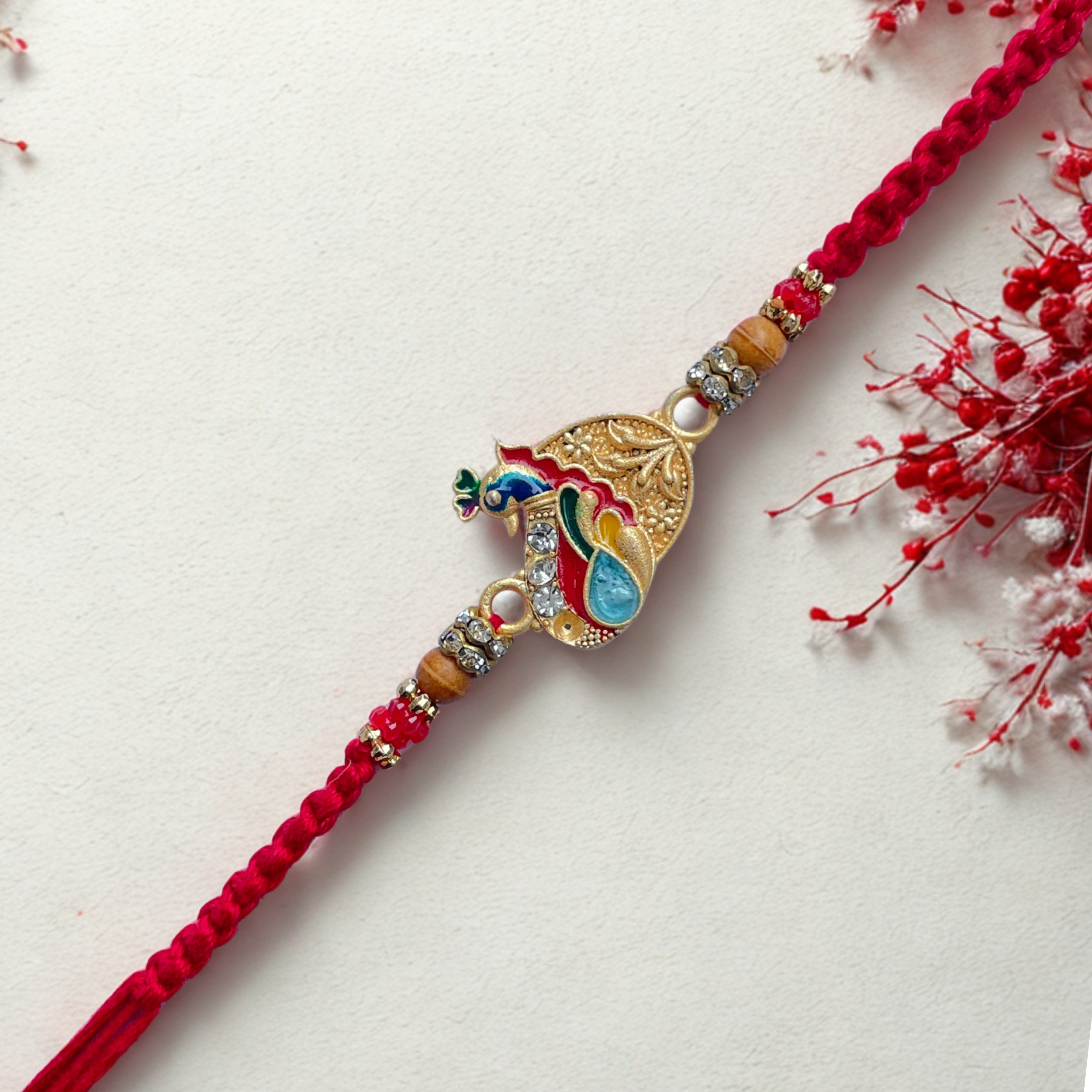 Elegant Peacock Design Rakhi with Stone and Bead Work