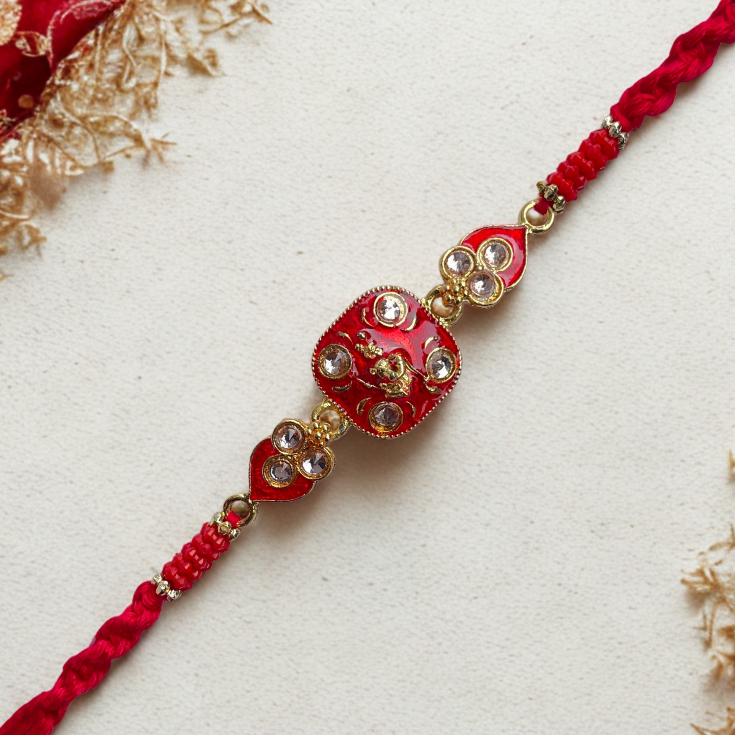 Elegant Red Kundan Rakhi with Divine Motif