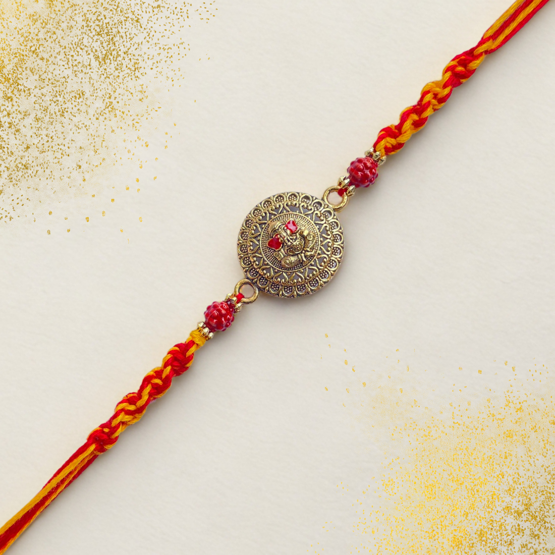 Antique Ganesha Rakhi with Red-Yellow Braided Thread