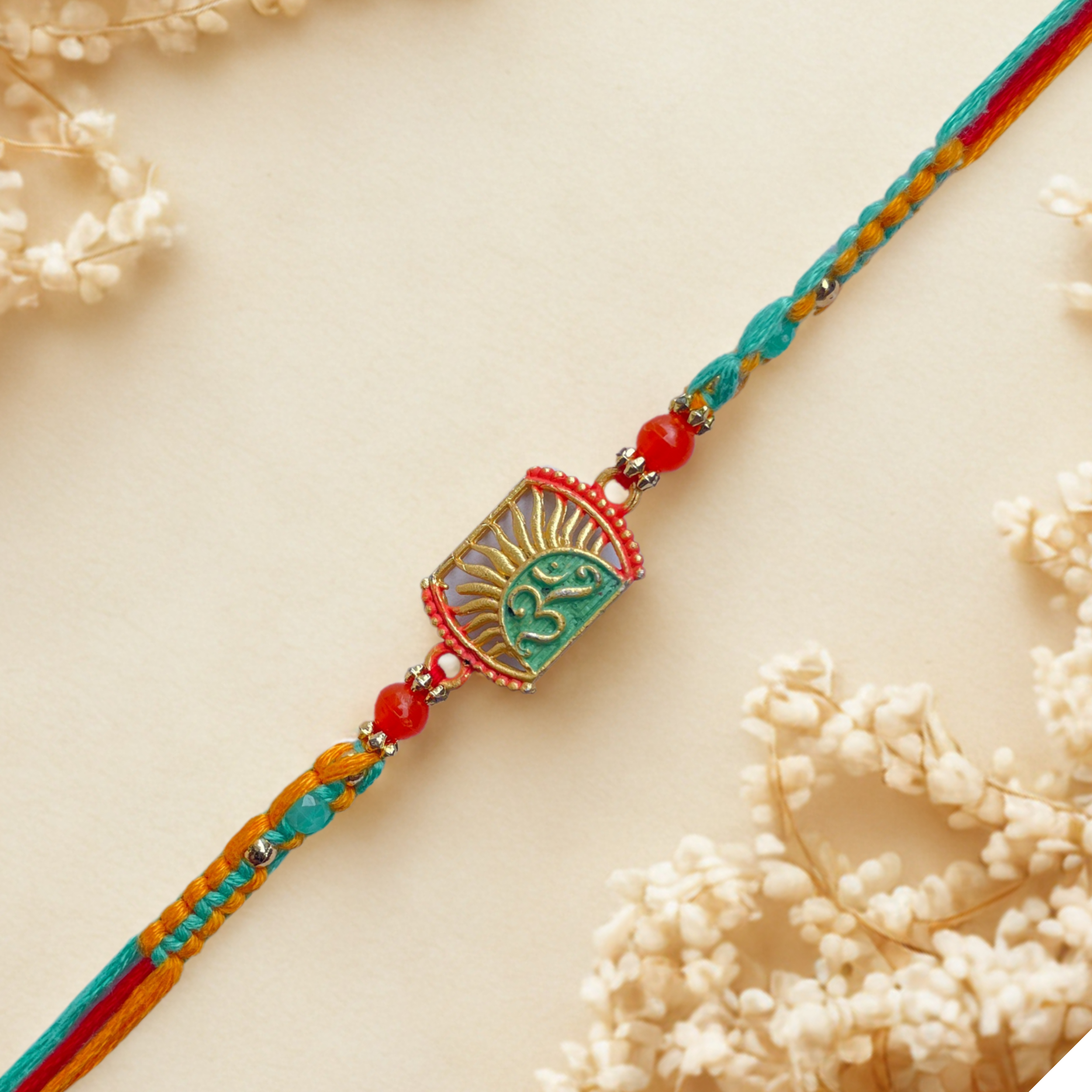 Divine Om Rakhi with Sunrise Design and Beads