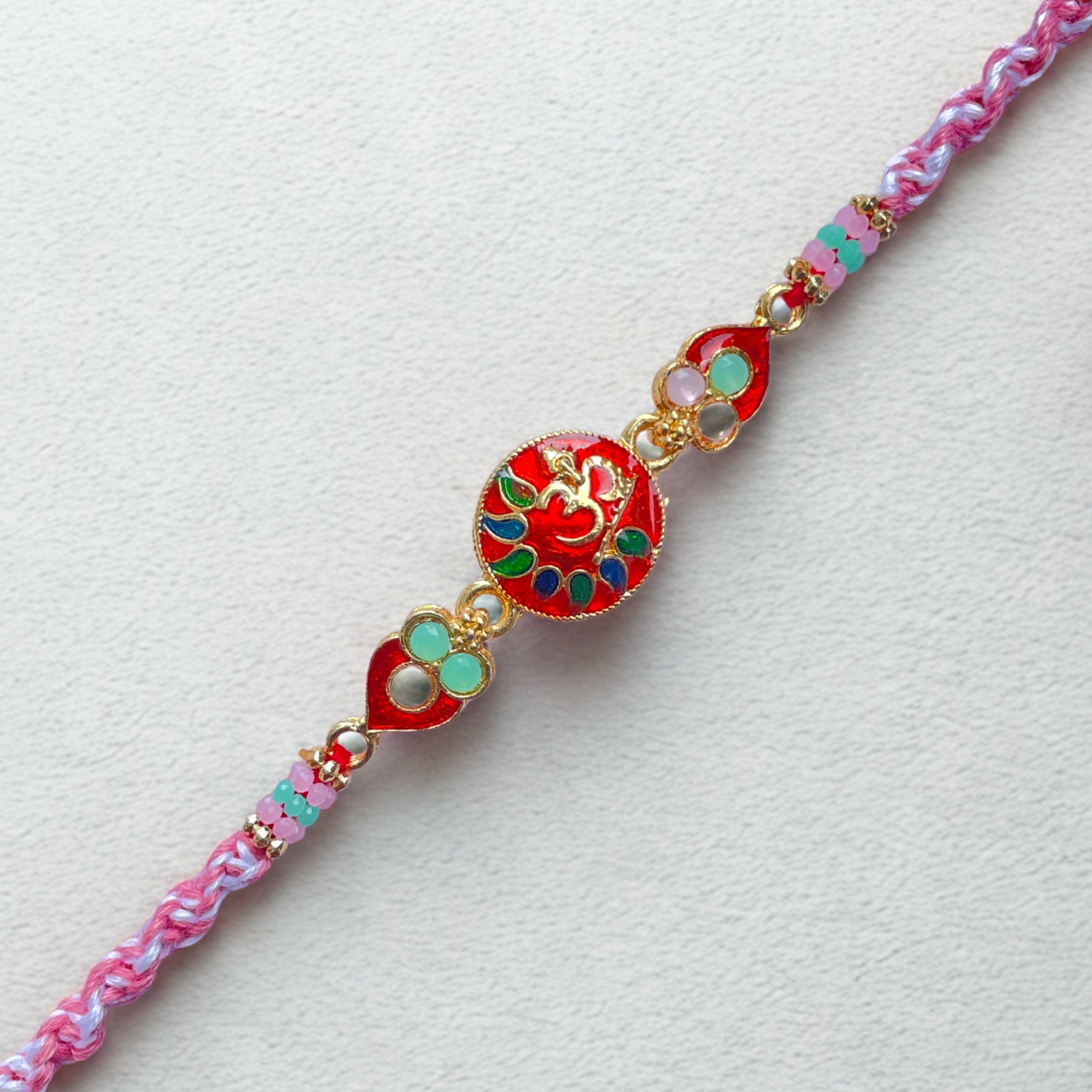 Elegant Red Om Rakhi with Bead Accents