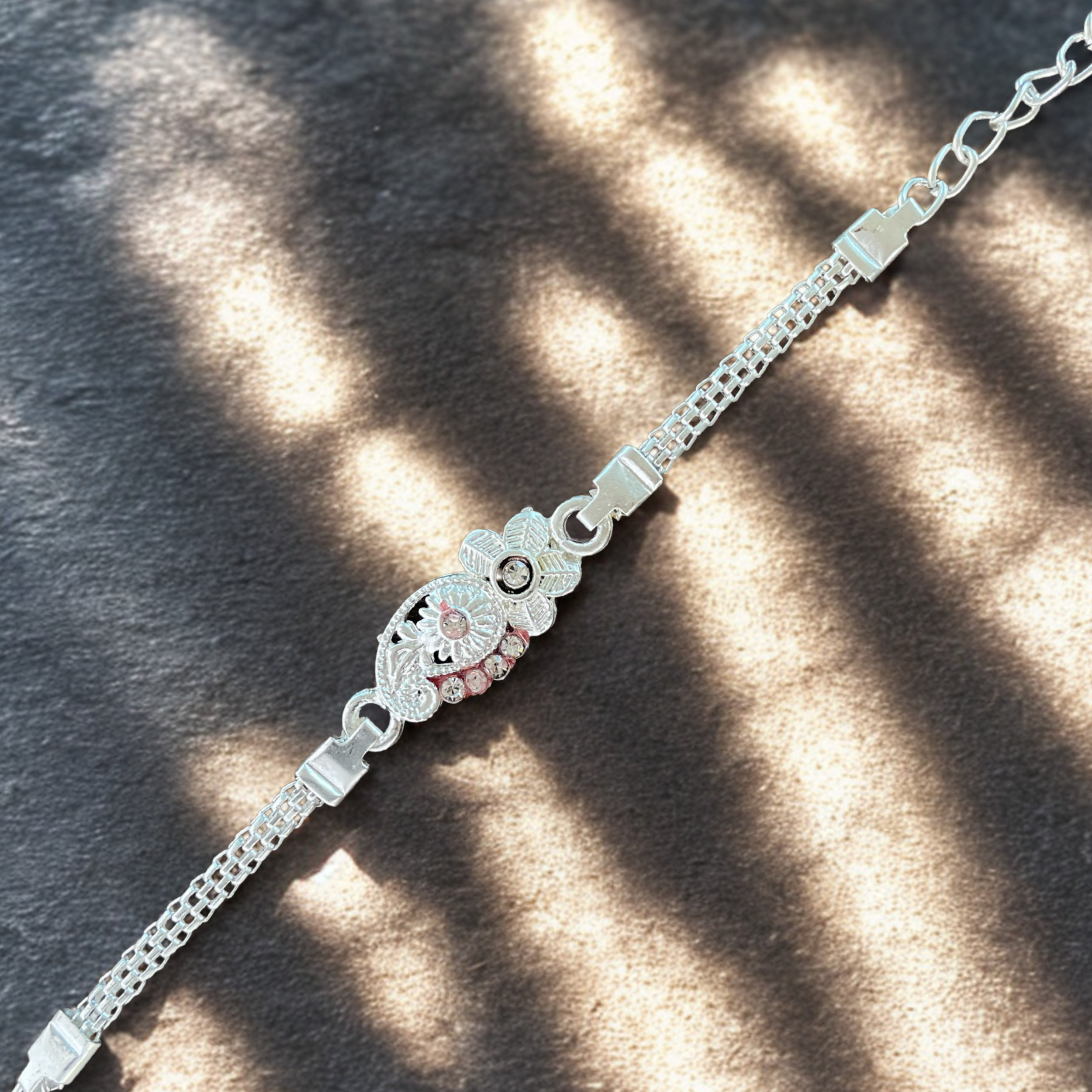Classic Silver Paisley Rakhi with White Stone Accents