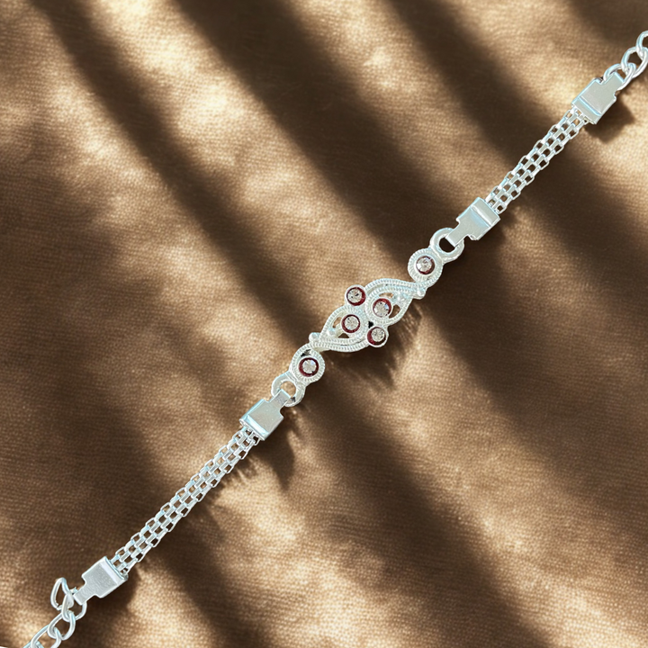 Stylish Silver-Tone Paisley Rakhi with Stone Accents