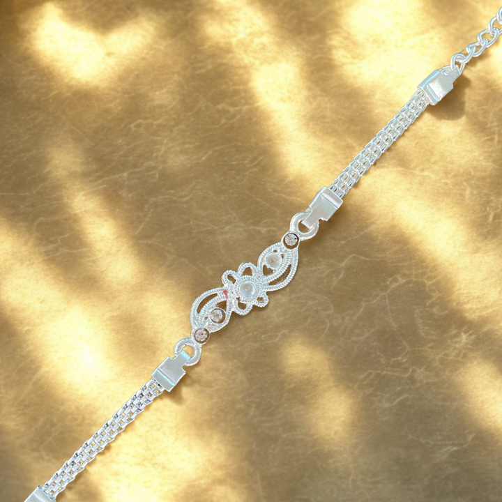 Elegant Silver-Toned Rakhi with Floral Filigree Center